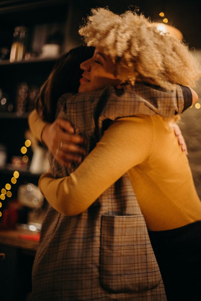 friends hugging We share our faith in many ways
