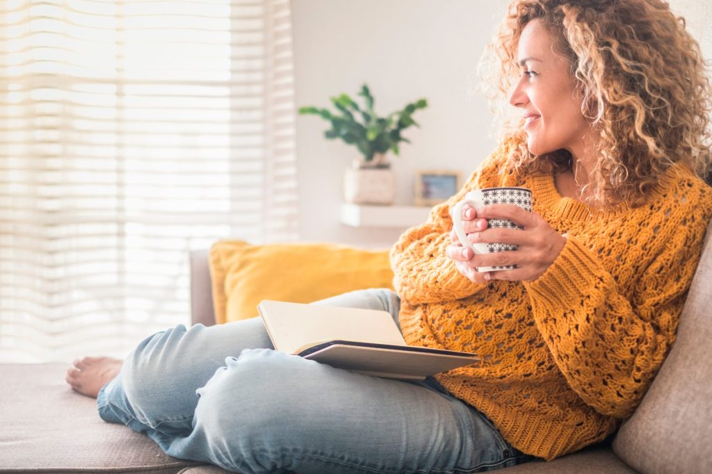 Woman,Have,Relax,At,Home,With,Cup,Of,Tea,And Woman drinking tea with a notebook